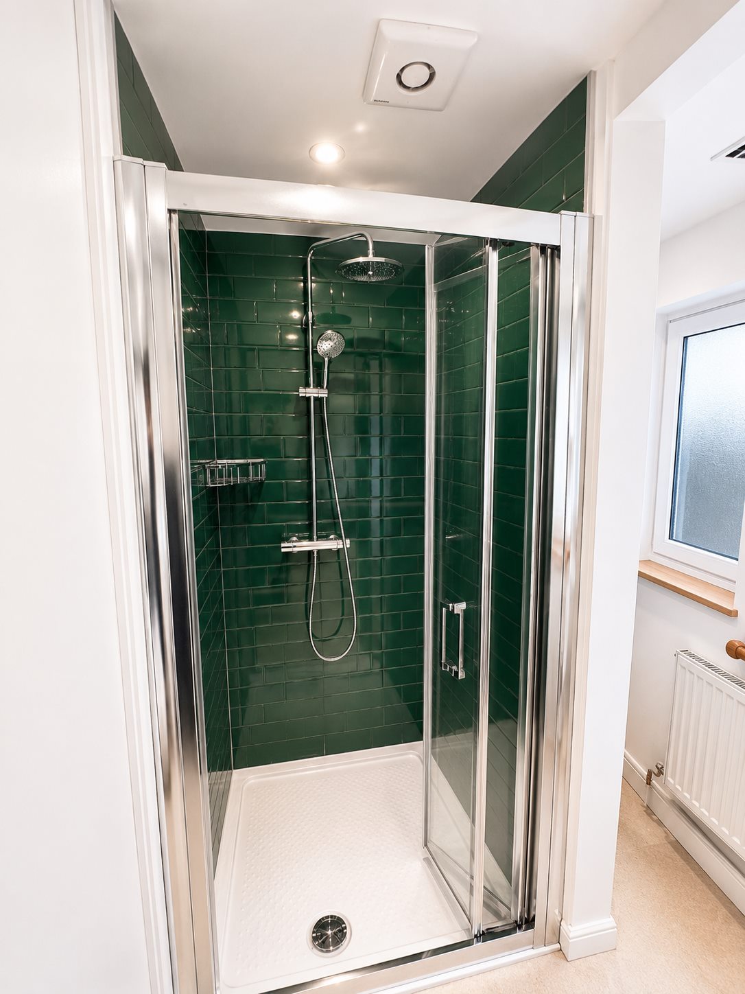 Green tiled shower plumbing and enclosure finish