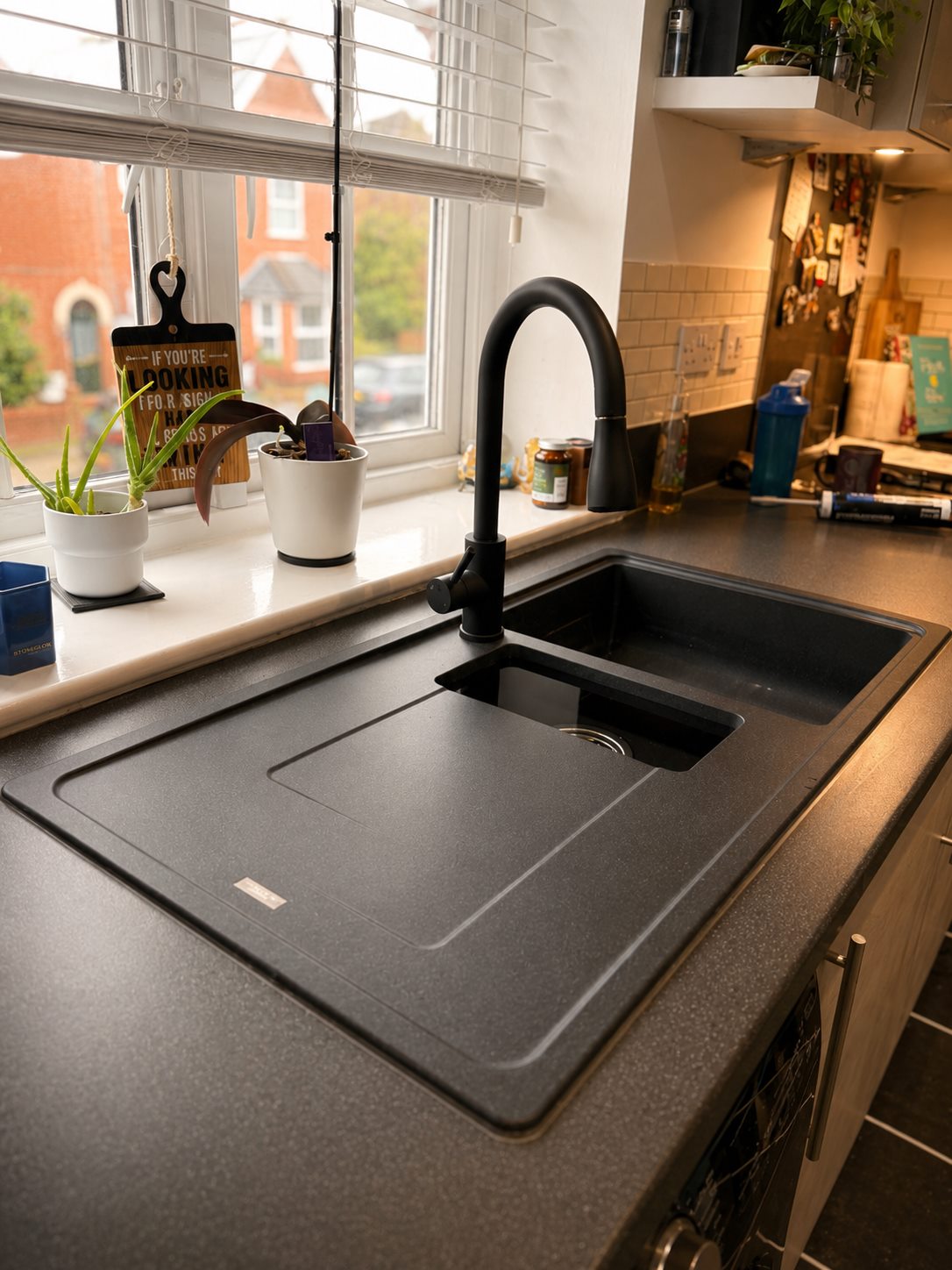 Kitchen sink area after tap and sink plumbing work