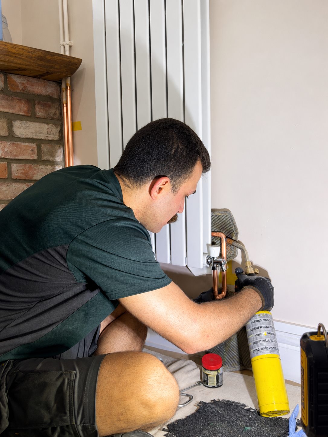 Rez working on radiator valves and pipework