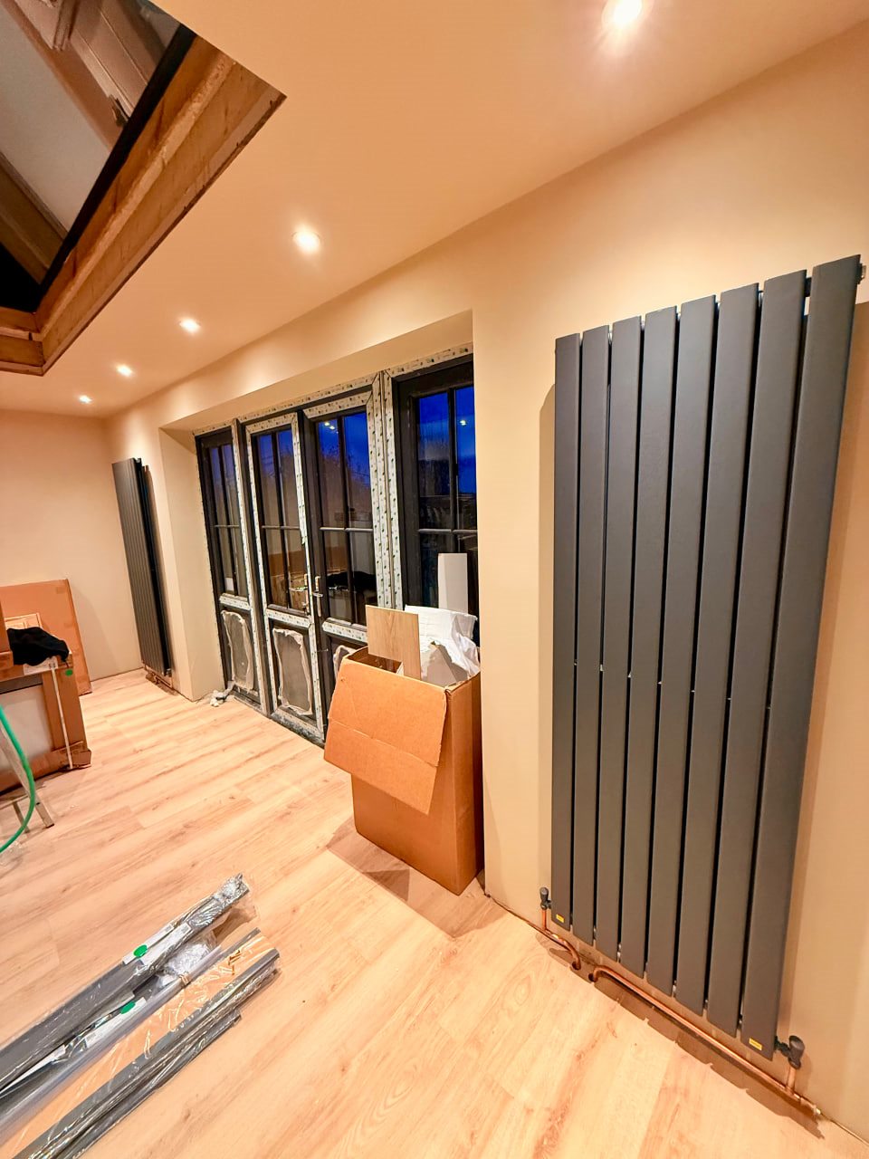 Modern grey radiator installed under windows