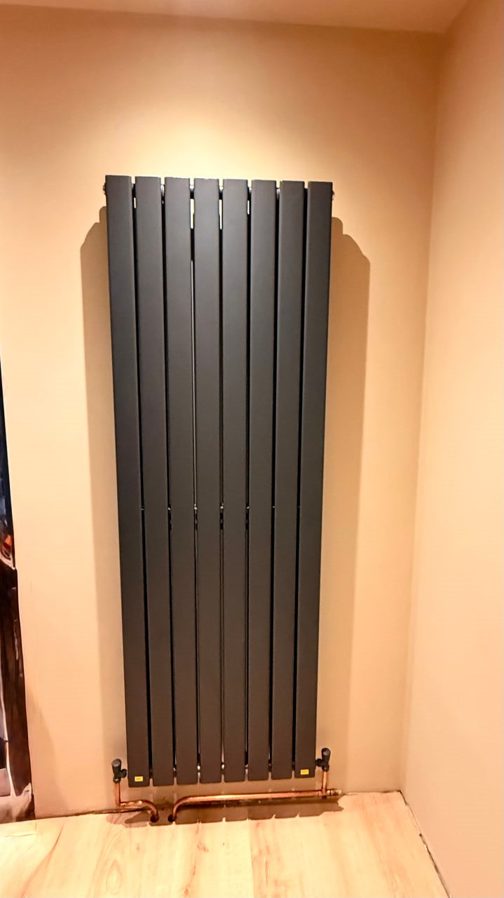 Tall radiator installation with neat pipework finish