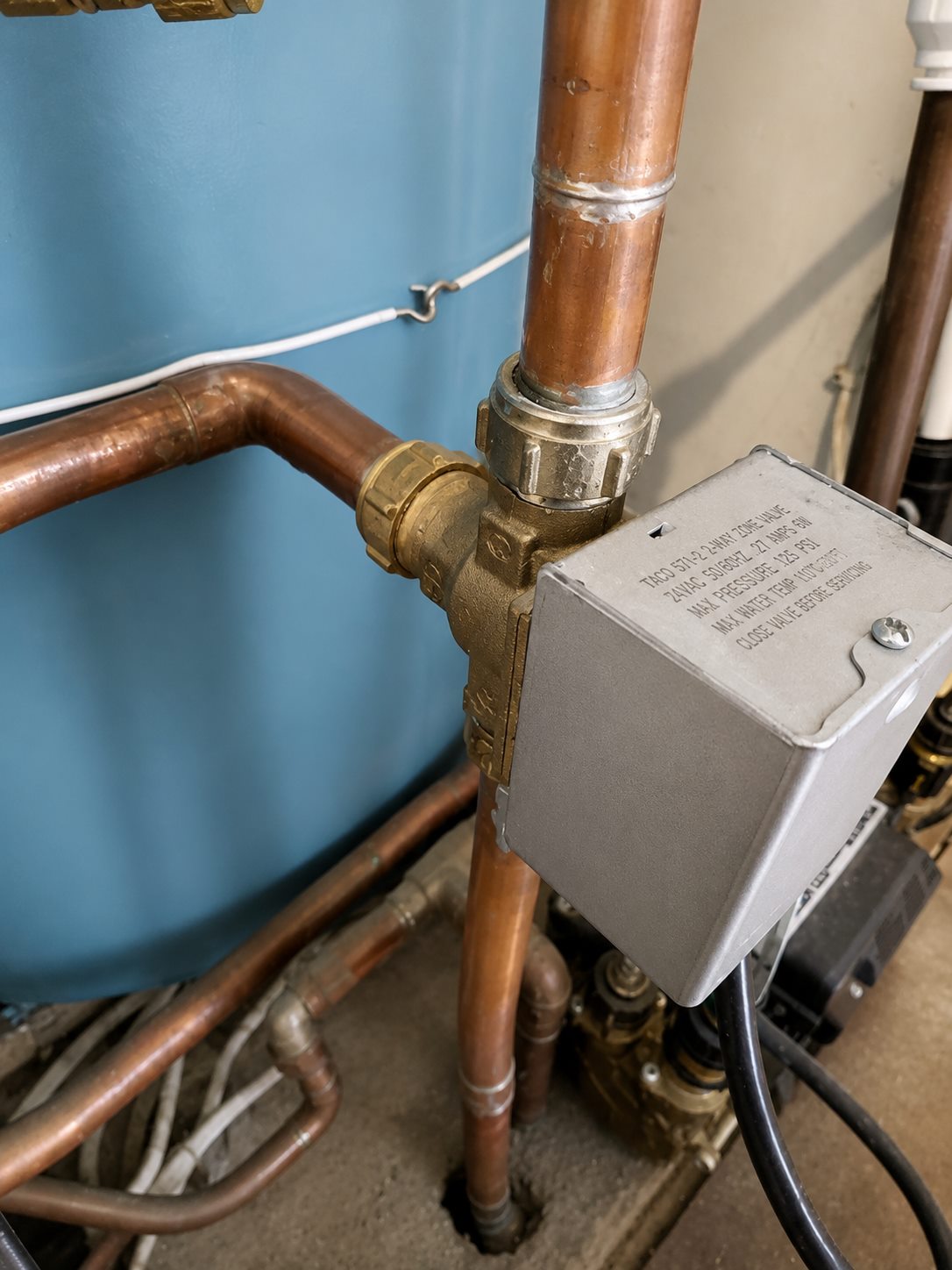 Copper pipework close-up around a vented cylinder